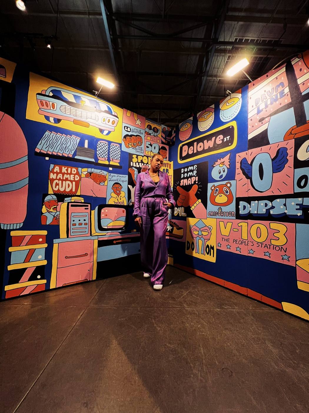 Lady CoCo in front of the Art, Beats + Lyrics mural